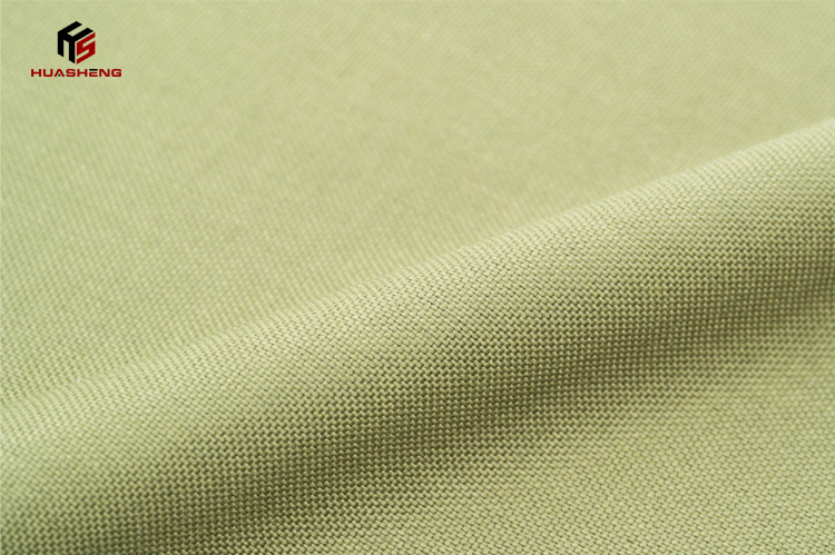 Close-up of green nylon fabric, showcasing its durable weave and color, ideal for tactical vest material.